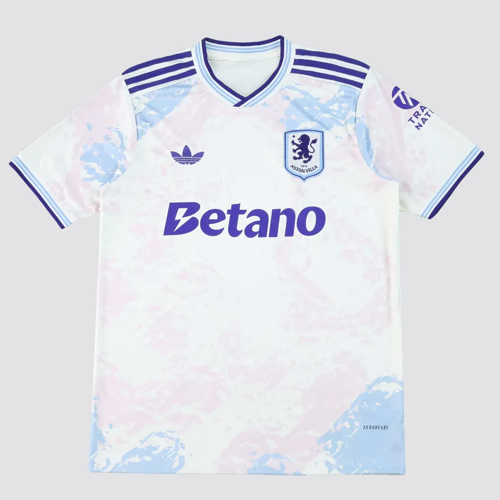 Camisa terceira do Aston Villa adidas 2025 2026 com grafismos inspirados em vitrais, base clara, detalhes bordô e escudo central do clube